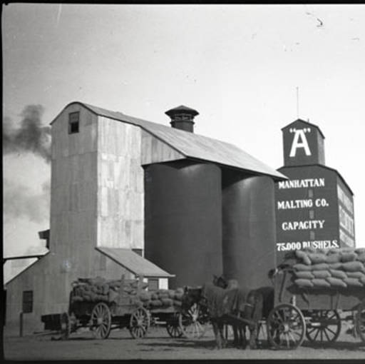 Manhattan grain elevator and loaded wagons - Montana Memory Project, Circa 1910 Circa 1910, Manhattan, MT grain elevator and loaded wagons - Montana Memory Project